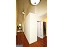 Bright hallway featuring hardwood floors, light walls, and modern lighting fixtures at 25 Pacific Ave, Sharpsburg, GA 30277