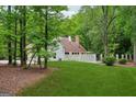 Spacious backyard featuring lush greenery and a white picket fence at 400 Peachtree Pkwy, Peachtree City, GA 30269