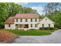 Charming two-story home with a welcoming front porch and well-manicured lawn at 400 Peachtree Pkwy, Peachtree City, GA 30269