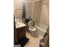 Bathroom featuring a shower and tub combo, a toilet with an open lid, and single sink vanity at 1975 Longwood Ct, Lithonia, GA 30058