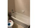 Bathroom bathtub featuring white tiling and a shower fixture with a toilet in view at 1975 Longwood Ct, Lithonia, GA 30058