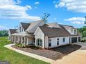 Spacious home with a three-car garage, well-maintained landscaping, and brick exterior at 357 Old Driver Rd, Whitesburg, GA 30185