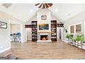 Inviting living room with a fireplace, built-in bookshelves, and wood-look tile flooring at 357 Old Driver Rd, Whitesburg, GA 30185