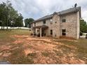 Brick home with a covered back patio and a large backyard at 441 Lilywood Dr, Mcdonough, GA 30253