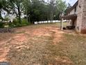 Large, expansive backyard with a covered back patio at 441 Lilywood Dr, Mcdonough, GA 30253