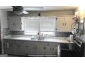 Efficient kitchen with white cabinets and stainless steel sink at 5780 Hill Rd, Powder Springs, GA 30127