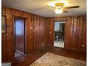 Living room with wood paneling and a ceiling fan at 5780 Hill Rd, Powder Springs, GA 30127