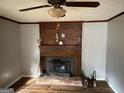 Warm living room with a brick fireplace and wood-look flooring at 5780 Hill Rd, Powder Springs, GA 30127