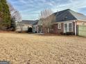 Spacious backyard view, showcasing the home's exterior, patio, and well-maintained lawn at 410 Oakpark Ter, Mcdonough, GA 30253