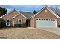 Charming brick home with a well-maintained front yard and a two-car garage at 410 Oakpark Ter, Mcdonough, GA 30253