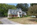 A charming two-story home featuring dormer windows, red shutters, and a spacious front yard at 250 Clearview Cir, Mcdonough, GA 30253