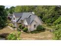 Two-story home showcasing meticulously maintained landscaping, shingle siding, and lush greenery, adding to its curb appeal at 250 Clearview Cir, Mcdonough, GA 30253