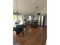 Kitchen with grey cabinets, stainless steel appliances, island, and dining table at 6070 Ridge Way, Douglasville, GA 30135