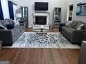 Cozy living room with couches, decorative rug, fire place, and mirrored display cabinets at 6070 Ridge Way, Douglasville, GA 30135