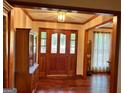 Elegant foyer with wood floors and a beautiful wood front door with sidelights at 110 The Farm Rd, Mcdonough, GA 30252