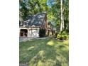 Spacious three-car garage with additional parking and well-manicured lawn at 110 The Farm Rd, Mcdonough, GA 30252