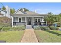 Beautiful home with a covered porch, landscaped yard, and a walkway leading to the entrance at 1449 Wadley Ave, East Point, GA 30344