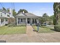 Charming home with a covered front porch and well-maintained landscaping at 1449 Wadley Ave, East Point, GA 30344