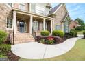 Inviting front entrance features a brick pathway, manicured landscaping, and a stately front door at 3820 Preserve Crossing Ln, Cumming, GA 30040