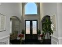 Elegant foyer with soaring ceilings, arched doorways, and ornate double doors at 116 Kalsum Trl, Ellenwood, GA 30294