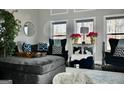 Comfortable living area featuring plush seating, decorative pillows, and ample natural light at 116 Kalsum Trl, Ellenwood, GA 30294
