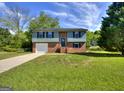 Inviting exterior view of a two-story brick home with a well-kept lawn and blue trim accents at 130 Belmont Farms Dr, Ellenwood, GA 30294