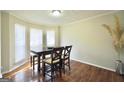 Bright dining room featuring natural light, wood floors, and a stylish table set at 701 Monticello Ln, Mcdonough, GA 30253