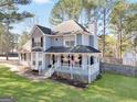 Beautiful exterior of home with a welcoming covered front porch and large yard at 701 Monticello Ln, Mcdonough, GA 30253