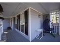 Relaxing covered porch with a hanging chair and view of the home's exterior at 701 Monticello Ln, Mcdonough, GA 30253