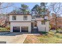 Charming two-story home with a two-car garage, neutral color scheme, and attractive landscaping at 5284 Silver Creek Sw Dr, Lilburn, GA 30047