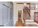 Inviting foyer showcases hardwood floors, a staircase, and a view into a stylish living area at 5284 Silver Creek Sw Dr, Lilburn, GA 30047