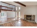 Spacious living room features hardwood floors, a stone fireplace, and natural light from tall windows at 5284 Silver Creek Sw Dr, Lilburn, GA 30047