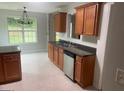 Functional kitchen featuring stainless steel appliances, dark countertops, and wood cabinets at 127 Jenny Rd, Grantville, GA 30220