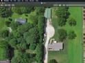 Birds-eye view of home featuring mature trees, a long driveway, and several outbuildings on lush acreage at 72 S Bethany Rd, Mcdonough, GA 30252