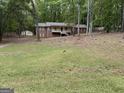 A charming two-story home with a covered porch, set back from the street with a grassy front yard at 4081 Jodeco Rd, Stockbridge, GA 30281