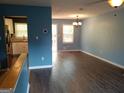 Inviting living room with hard wood floors that leads into a dining area and a kitchen at 4616 Hamlet Se Walk, Conyers, GA 30094