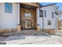 Elegant entryway featuring a stone facade, grand double doors, and inviting stone steps at 1620 Saddle Ridge Way, Sandy Springs, GA 30350