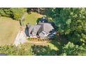 Overhead shot of charming home with manicured lawn, surrounded by mature trees at 1231 Hillview Rd, Hampton, GA 30228