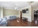 Bright living room with hardwood floors, white trim, and a decorative ceiling fan at 1231 Hillview Rd, Hampton, GA 30228