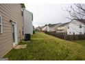 Spacious backyard featuring a lush lawn, privacy fence, and ample room for outdoor activities at 1579 Leonard St, Hampton, GA 30228