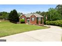 Inviting brick home with manicured lawn, charming front entrance, and well-maintained landscaping at 1112 Haver Ct, Mcdonough, GA 30252