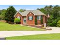 Inviting brick home with manicured lawn, charming front entrance, and well-maintained landscaping at 1112 Haver Ct, Mcdonough, GA 30252
