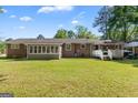 Spacious backyard featuring a well-maintained lawn, sunroom, and deck perfect for entertaining at 118 Duvall Dr, Stockbridge, GA 30281
