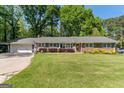 Beautiful brick ranch home with a well-maintained lawn and a classic, inviting facade at 118 Duvall Dr, Stockbridge, GA 30281