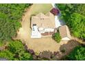Aerial view of a large home with a spacious backyard surrounded by lush greenery, offering privacy and tranquility at 21 Highbush Ct, Sharpsburg, GA 30277