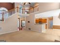 Open-concept living room with a staircase and a view of the kitchen bar at 21 Highbush Ct, Sharpsburg, GA 30277