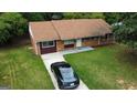 Inviting single-story home with a classic brick exterior, well-manicured lawn, and a convenient driveway with parking at 7336 Howard Cir, Jonesboro, GA 30236