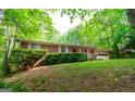 Beautiful brick home with a well-maintained lawn and mature trees providing shade and privacy at 215 Ridge Rd, Tyrone, GA 30290