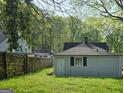 Backyard featuring wooden fence, greenery, and utility building at 2016 Conrad Se Ave, Atlanta, GA 30315