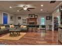 Open-concept living room with a cozy fireplace and hardwood floors at 678 Oak Grove Rd, Mcdonough, GA 30253